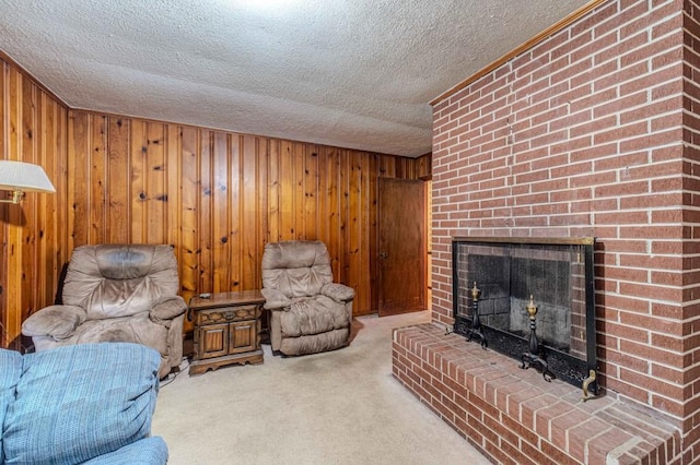 living room featuring a textured ceiling, carpet floors, a brick fireplace, and wooden walls