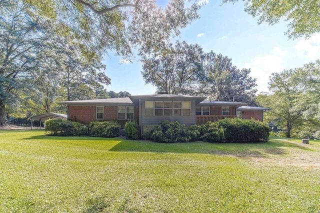 ranch-style house with a front lawn and brick siding