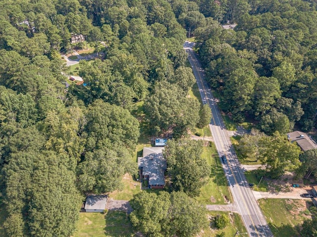 drone / aerial view with a wooded view