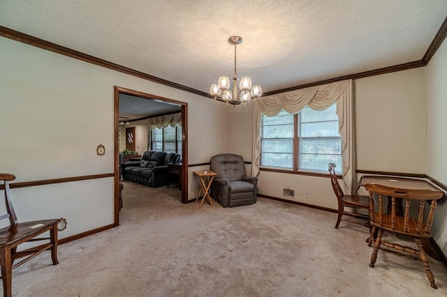 sitting room featuring a chandelier, ornamental molding, a textured ceiling, and light colored carpet