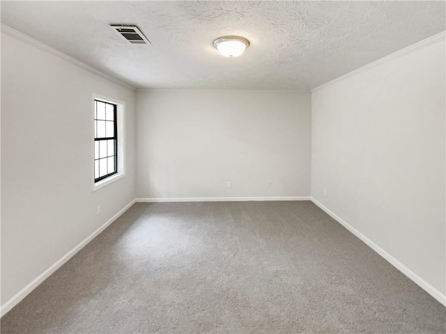 unfurnished room with carpet, ornamental molding, and a textured ceiling