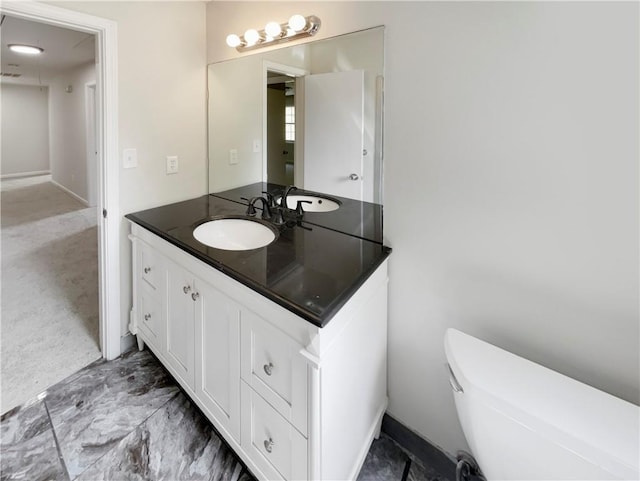 bathroom featuring vanity and toilet