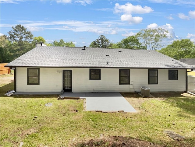 back of property with central air condition unit, a yard, and a patio