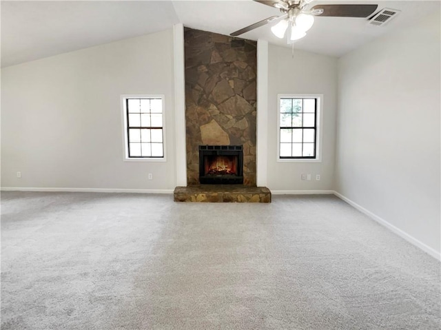 unfurnished living room featuring ceiling fan, carpet floors, a fireplace, and vaulted ceiling