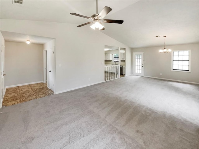 unfurnished living room featuring carpet flooring, ceiling fan with notable chandelier, and lofted ceiling