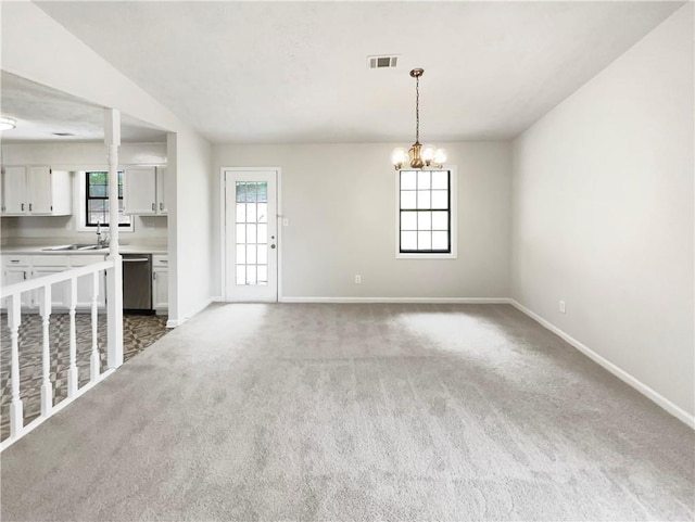 unfurnished living room with light carpet, a chandelier, vaulted ceiling, and sink