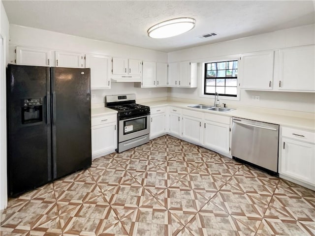 kitchen with white cabinetry, sink, a textured ceiling, and appliances with stainless steel finishes