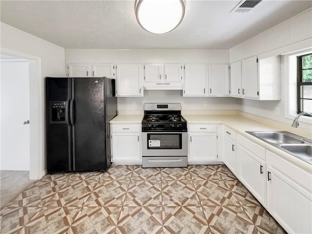 kitchen featuring black fridge with ice dispenser, white cabinetry, and gas range