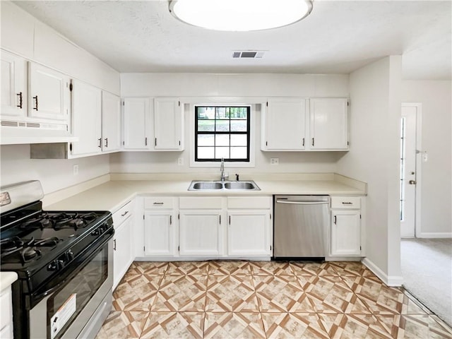 kitchen featuring stainless steel appliances, extractor fan, white cabinetry, and sink