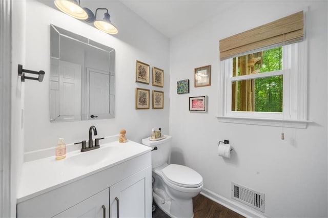 bathroom featuring hardwood / wood-style flooring, vanity, and toilet