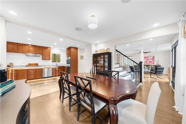 dining room with ceiling fan and light wood-type flooring