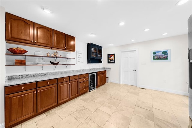 bar featuring light tile patterned flooring, beverage cooler, and light stone countertops