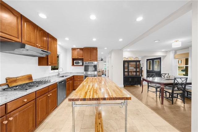 kitchen featuring butcher block counters, appliances with stainless steel finishes, sink, and a wealth of natural light