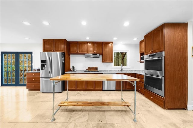 kitchen with a center island, sink, french doors, and appliances with stainless steel finishes