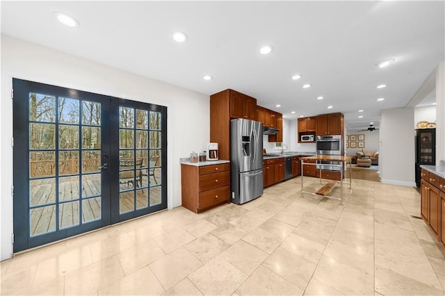 kitchen with stainless steel appliances, sink, ceiling fan, and french doors