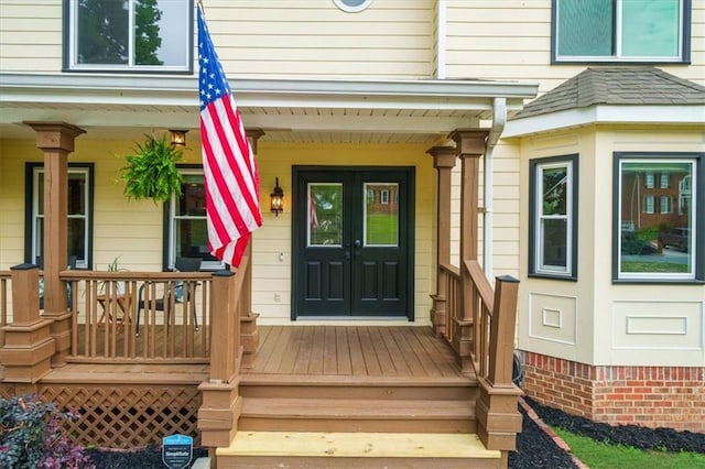 view of exterior entry featuring covered porch