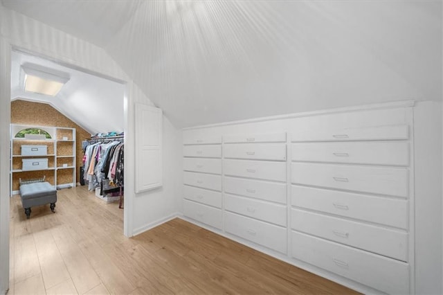 spacious closet featuring lofted ceiling and light hardwood / wood-style floors