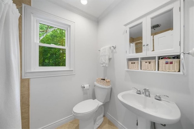 bathroom featuring sink, curtained shower, ornamental molding, and toilet