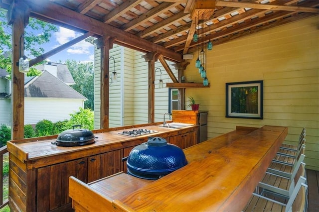 exterior space featuring beam ceiling, sink, wood ceiling, and wood walls