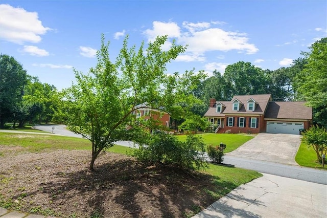 cape cod house featuring a garage and a front lawn