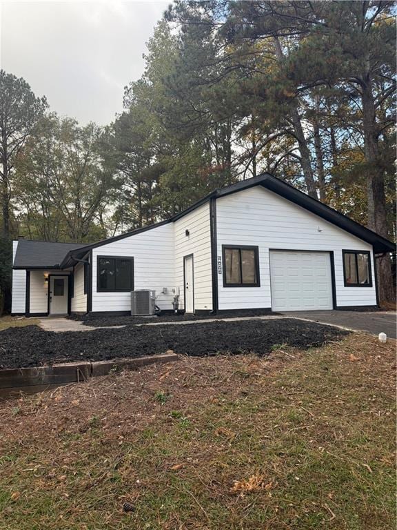 exterior space featuring a garage and cooling unit