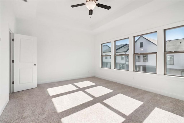 unfurnished room featuring light carpet and ceiling fan