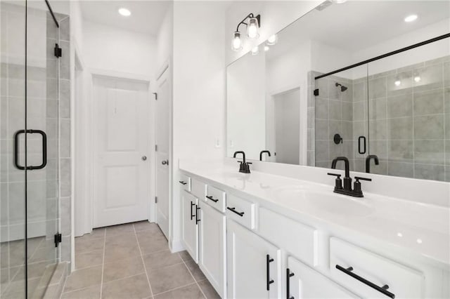 bathroom with tile patterned floors, vanity, and a shower with shower door