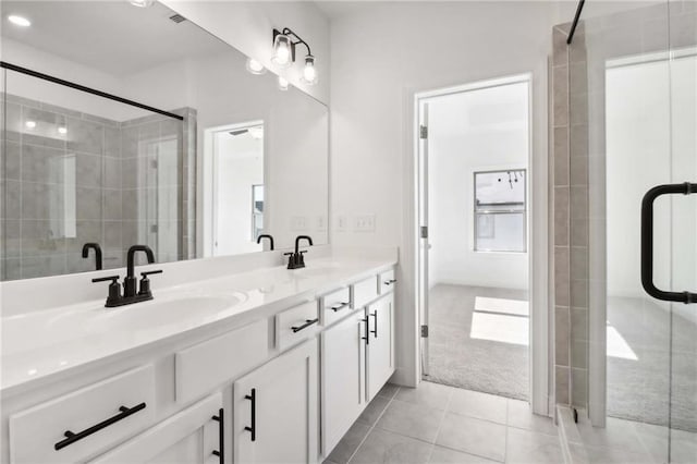 bathroom with tile patterned floors, vanity, and walk in shower