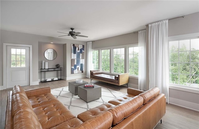 living room with light wood-type flooring, a wealth of natural light, and ceiling fan