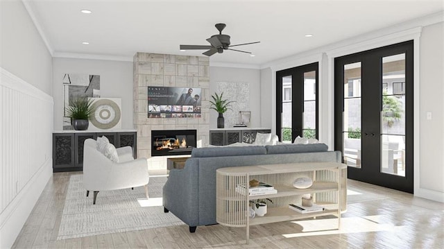 living room featuring french doors, crown molding, and light hardwood / wood-style flooring