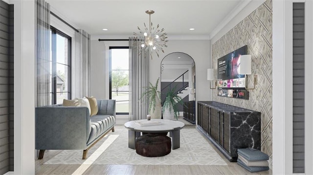 living area featuring a notable chandelier, crown molding, and light hardwood / wood-style flooring