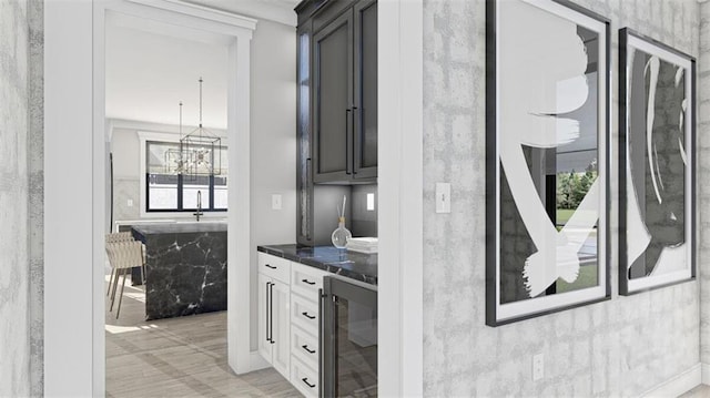 kitchen with white cabinets, a healthy amount of sunlight, beverage cooler, and pendant lighting