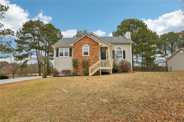 view of front of property featuring a chimney and a front lawn