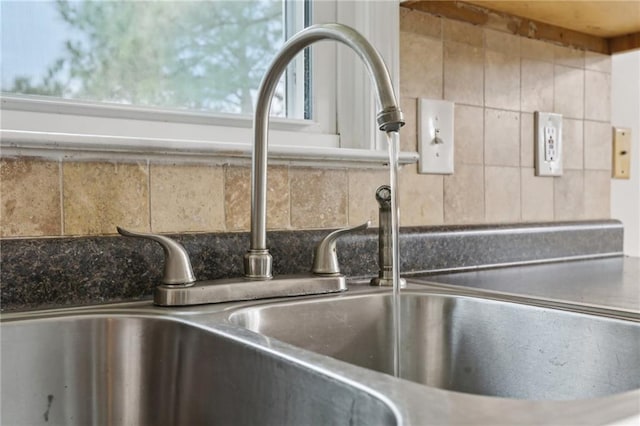 room details featuring backsplash and a sink