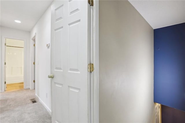 hall with recessed lighting, baseboards, light carpet, and visible vents