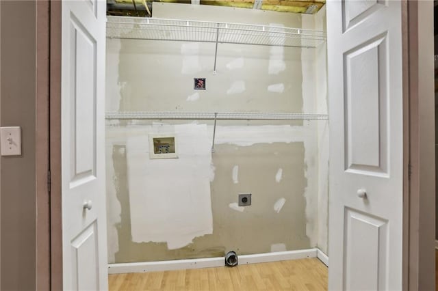 clothes washing area with electric dryer hookup, light wood-style flooring, hookup for a washing machine, and laundry area