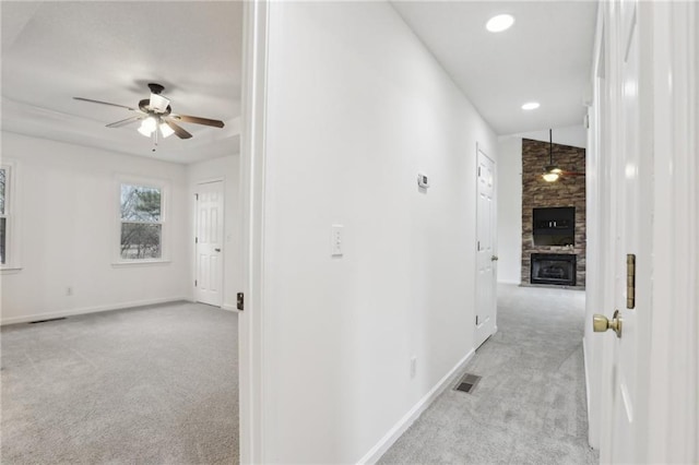 hall featuring recessed lighting, visible vents, light carpet, and baseboards