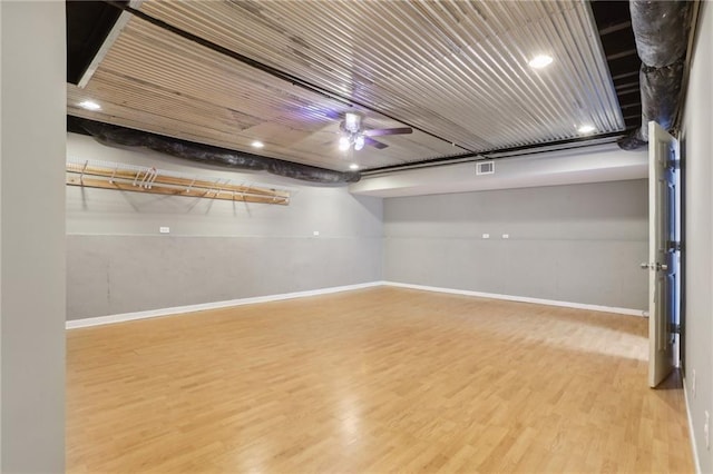 unfurnished room with visible vents, a ceiling fan, baseboards, and wood finished floors