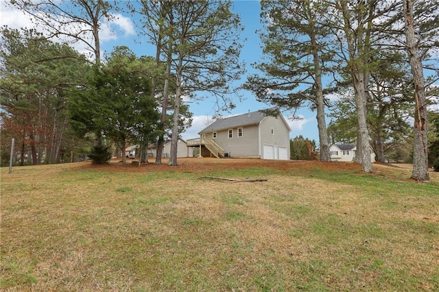 view of yard with stairs and an attached garage