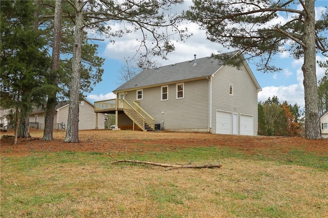 back of house with stairway, a yard, a garage, and a wooden deck