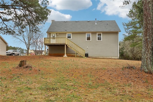 rear view of house with a deck, stairway, a lawn, and central AC