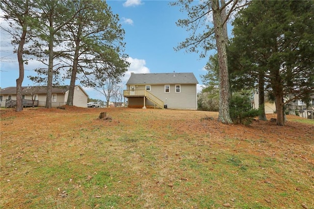 view of yard featuring stairway and a wooden deck