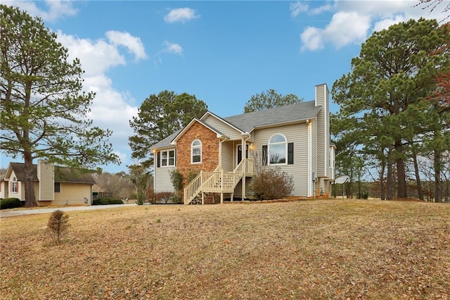 ranch-style home with a chimney and a front yard