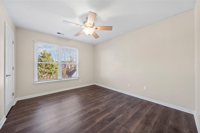 spare room with ceiling fan and dark wood-type flooring