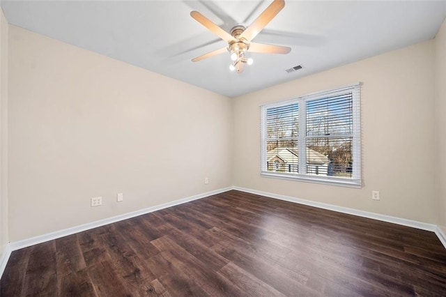 spare room featuring ceiling fan and dark hardwood / wood-style flooring