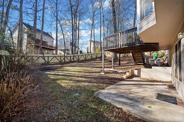 view of yard featuring a patio and a wooden deck