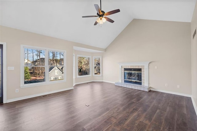 unfurnished living room with a fireplace, ceiling fan, and dark wood-type flooring