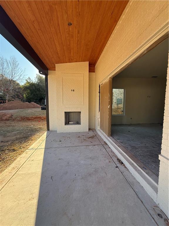 view of patio / terrace featuring a large fireplace