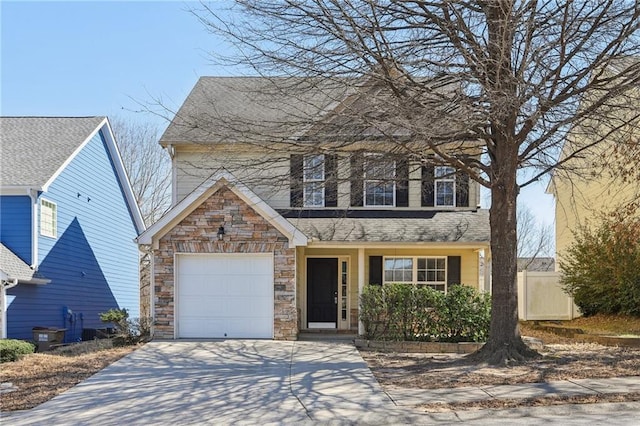 traditional home featuring a garage, stone siding, roof with shingles, and concrete driveway