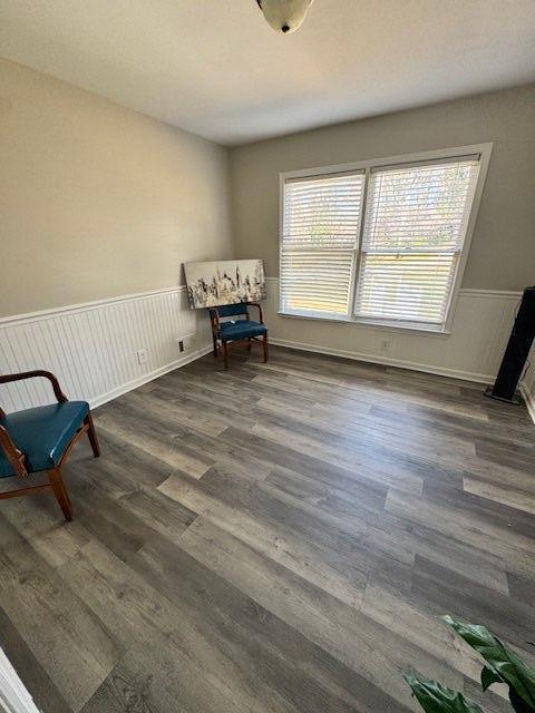 unfurnished room with wainscoting and wood finished floors